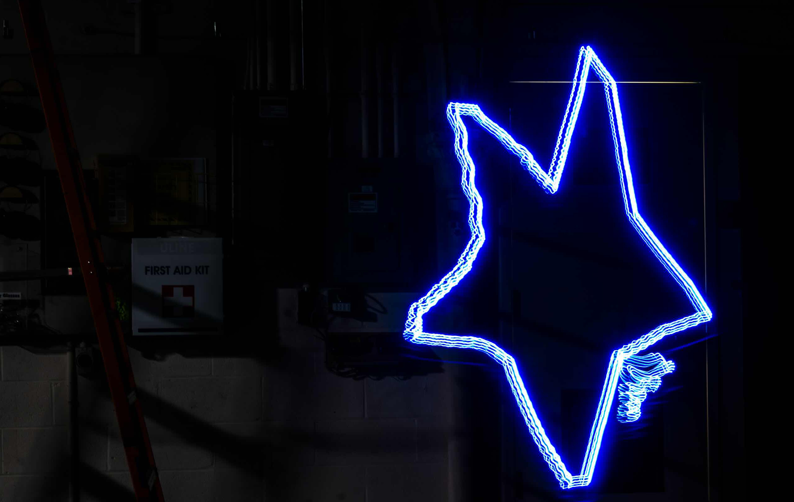 RapLum printed star. Bright and blue on a shadowed background. A little messy, but legible.